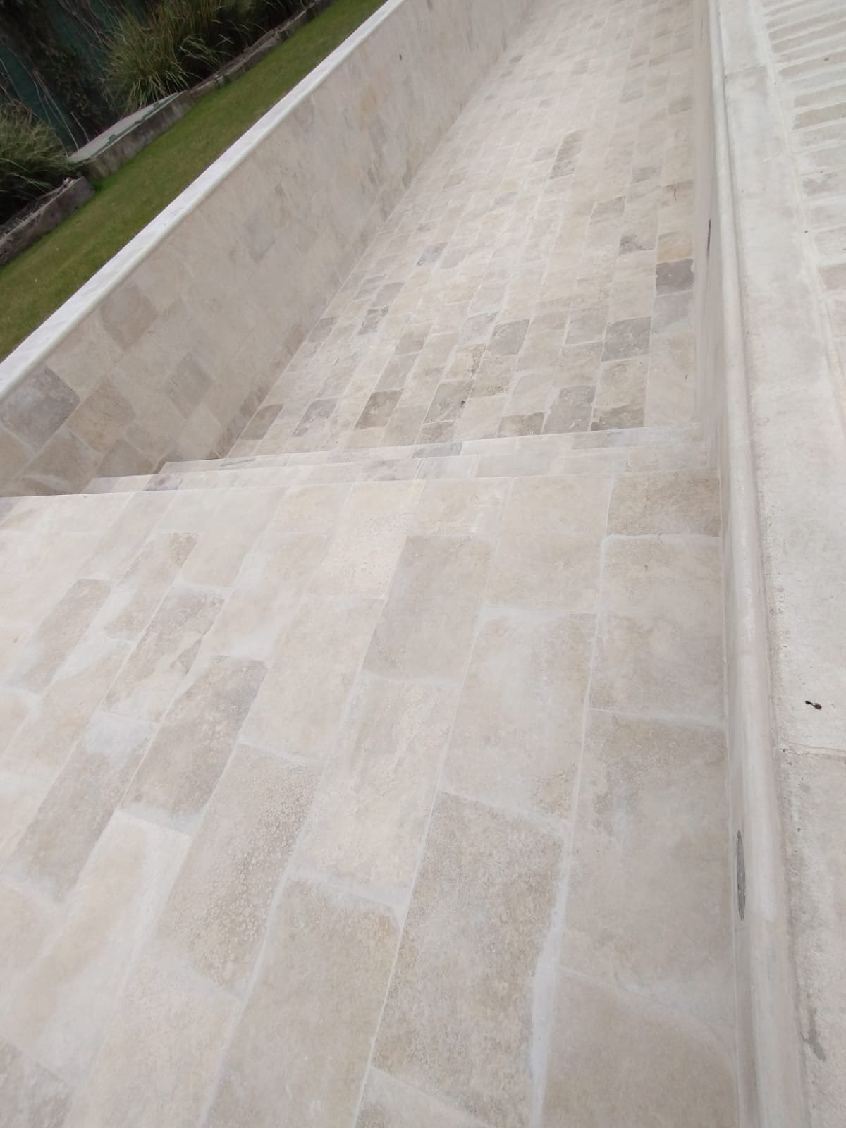 Escalones de piscina revestidos en piedra travertino
